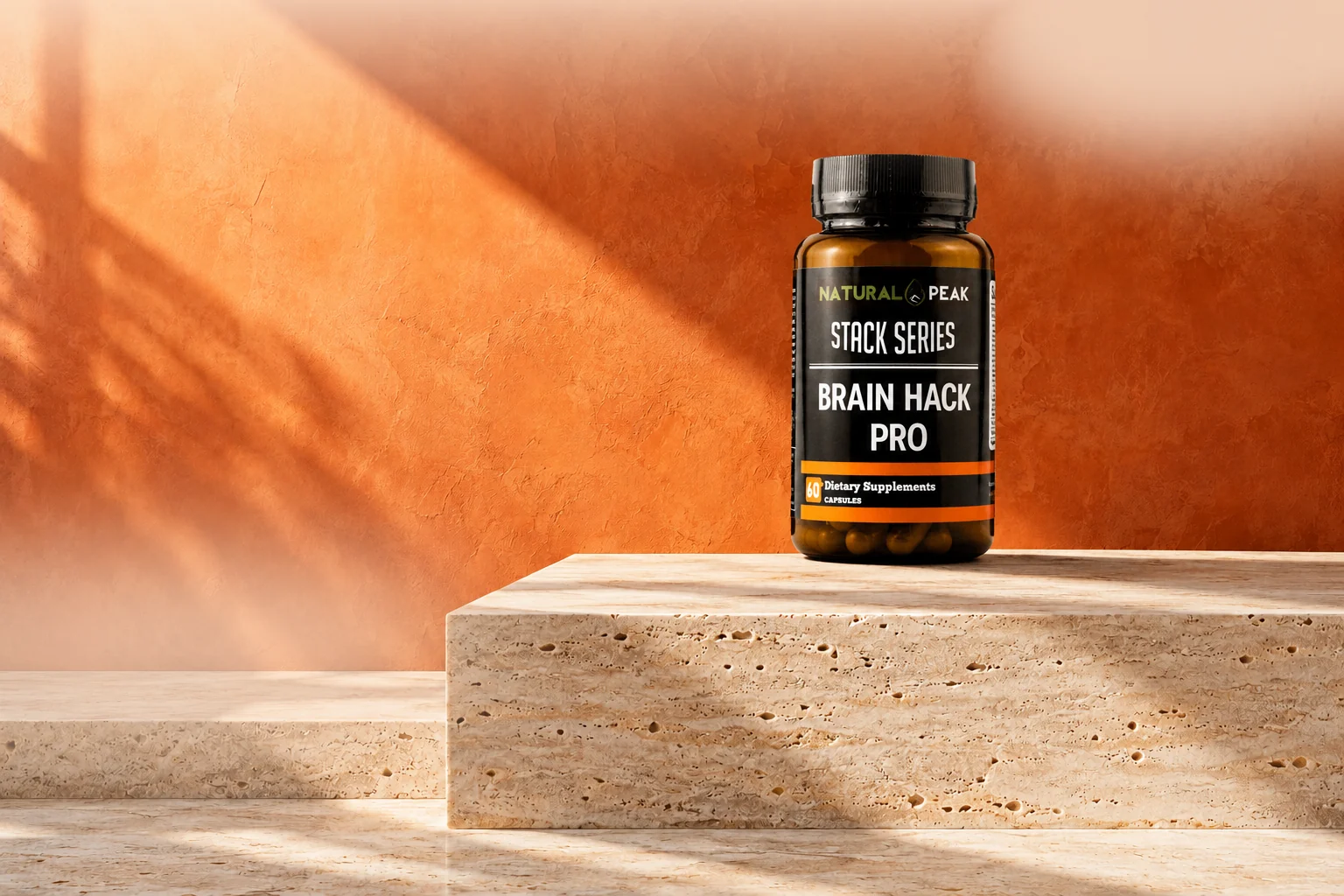 A BrainHack Pro bottle on a travertine plinth against a sunlit orange wall